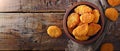 Delicious crispy fried breaded nuggets with ketchup on black plate. Dark background Royalty Free Stock Photo