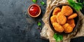 Delicious crispy fried breaded nuggets with ketchup on black plate. Dark background Royalty Free Stock Photo