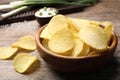 Delicious crispy potato chips in bowl on table, closeup Royalty Free Stock Photo