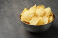 Delicious crispy potato chips in bowl on table Royalty Free Stock Photo