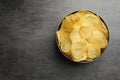 Delicious crispy potato chips in bowl on table Royalty Free Stock Photo