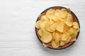 Delicious crispy potato chips in bowl on table, space for text Royalty Free Stock Photo