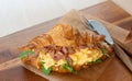 Delicious croissant with bacon scrambled egg