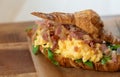 Delicious croissant with bacon scrambled egg