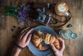 Delicious Croissant with Cup Coffee on wooden Table - typical Parisian breakfast Royalty Free Stock Photo