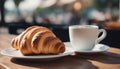 Delicious croissant. Fresh croissant on a table in a street cafe. AI generated