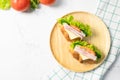 Delicious croissant sandwich with fresh Ham, cheese,  tomato, cucumber and lettuce on white background. Royalty Free Stock Photo