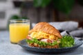 Delicious croissant sandwich with ham, cheese and scrambled eggs Royalty Free Stock Photo
