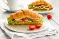 Delicious croissant sandwich on wooden table. Healthy breakfast