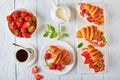 Croissant sandwiches with fresh ripe strawberries Royalty Free Stock Photo