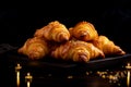 Delicious croissants with chicken filling on a black table