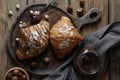 Delicious croissants with chocolate and nuts on wooden table, flat lay