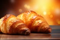 Delicious croissants placed on right side against sandy beige backdrop for visually appealing image