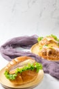 Delicious croissants sandwichs and Sub sandwich served on round wooden plate. Royalty Free Stock Photo