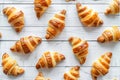 Delicious croissants on a white wooden background. Flat lay shot