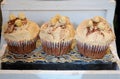 Delicious cup cakes with vanilla cream and nuts