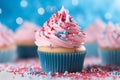 Delicious cupcake decorated with blue and pink frosting and colorful sprinkles. Dessert served at gender reveal or a baby shower