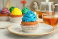 Delicious cupcake with light blue cream on table Royalty Free Stock Photo