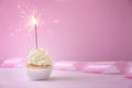 Delicious cupcake with sparkler on color background Royalty Free Stock Photo
