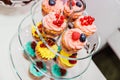 Delicious cupcakes with berries on a three-tier glass plate Royalty Free Stock Photo