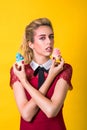 Delicious cupcakes. Fashion girl eating food, eating colorful cupcakes. Sensual woman in elegant dress. Fashion makeup, hairstyle