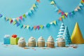 Delicious cupcakes with sugar sprinkles, party hats and gifts on blue background