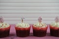 Delicious cupcakes topped with a miniature person figurine holding a sign indicating i love Easter Royalty Free Stock Photo