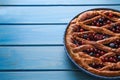 Delicious currant pie and fresh berries on blue wooden table, closeup. Space for text Royalty Free Stock Photo