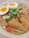 Delicious curry chicken noodle with tofu and boiled egg