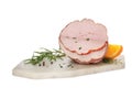 Delicious cut ham with herbs, orange slice and peppercorns isolated on white