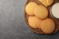 Delicious Danish butter cookies and milk on grey table, top view. Space for text