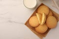 Delicious Danish butter cookies and milk on white marble table, flat lay. Space for text