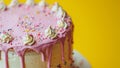 A delicious, delicate cake on a yellow background with pink icing. A birthday dessert that looks beautiful and