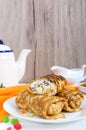 Delicious delicate pancakes with cottage cheese and raisins on a white wooden background. Healthy breakfast. Vertical view