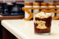 Delicious dessert with banana and biscuits chocolate pudding in glass cup on table Royalty Free Stock Photo