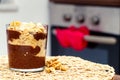 Delicious dessert with banana and biscuits chocolate pudding in glass cup on table