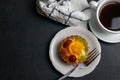 Delicious dessert with black coffee and fruit tart decorated with orange cherry and kiwi Royalty Free Stock Photo