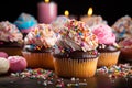 Delicious Dessert Cupcakes with Cream Topping and Sprinkle of Meses and Candy on Wooden Table