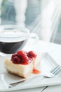 Delicious with dessert a piece of cherry cheesecake and black coffee on white tone wooden table Royalty Free Stock Photo