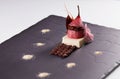 Delicious dessert with red pear and chocolate on a black surface Royalty Free Stock Photo