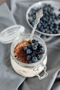 Delicious dessert: tiramisu in a glass jar and natural yogurt in a glass cup with fresh berries, strawberries and blueberries. Royalty Free Stock Photo