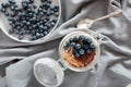 Delicious dessert: tiramisu in a glass jar and natural yogurt in a glass cup with fresh berries, strawberries and blueberries. Royalty Free Stock Photo