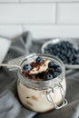 Delicious dessert: tiramisu in a glass jar and natural yogurt in a glass cup with fresh berries, strawberries and blueberries. Royalty Free Stock Photo