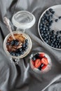 Delicious dessert: tiramisu in a glass jar and natural yogurt in a glass cup with fresh berries, strawberries and blueberries. Royalty Free Stock Photo