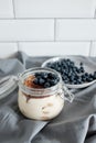 Delicious dessert: tiramisu in a glass jar and natural yogurt in a glass cup with fresh berries, strawberries and blueberries. Royalty Free Stock Photo