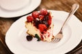 Delicious dessert on wooden background, defocused. Patisserie concept. Piece of cake with blackberries and raspberries