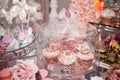 Delicious desserts at the wedding candy bar in the buffet area: muffins decorated with angels, cameo, sugar rosebuds and gold dye