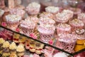 Delicious desserts at the wedding candy bar in the buffet area: muffins decorated with angels, sugar rosebuds and gold dye