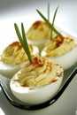 Delicious deviled eggs with creamy filling and paprika garnish on white plate Royalty Free Stock Photo