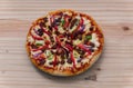 Delicious Devilled Chicken Pizza on a wooden surface overhead top view close-up photograph. mozzarella cheese and lots of spices